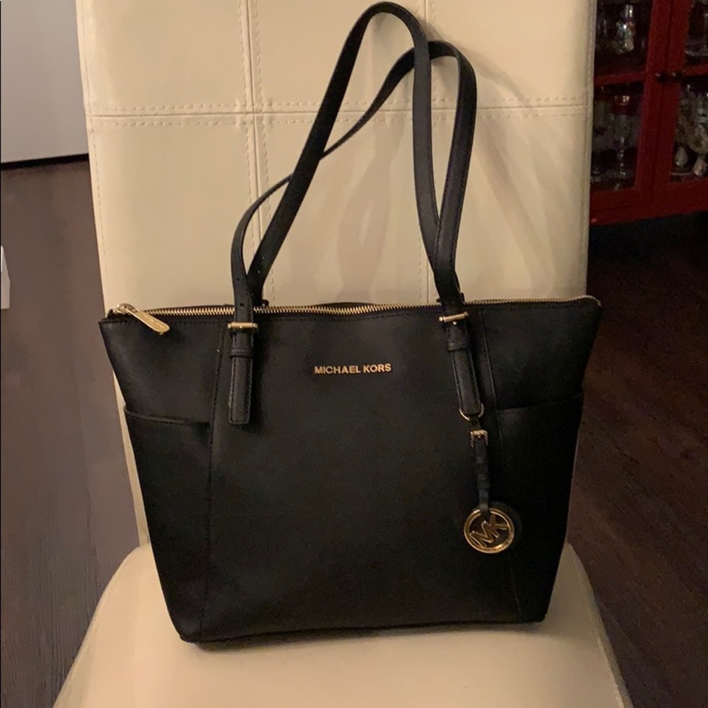 Genuine Michael Kors black purse. Zip closure